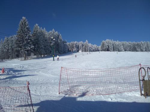 a group of people skiing down a snow covered slope at Javorník 88 in Javorník