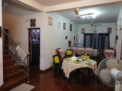 a dining room with a table and chairs at Takashi Homestay North Paravur Near Muziris in North Paravur