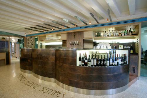 a bar with a bunch of bottles of wine at Allegria in Udine