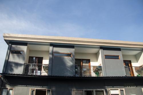 a building with a balcony on top of it at Ratna Villa 4 in Ubud