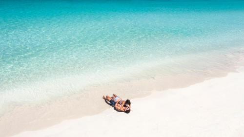 a group of people on a beach near the water at Couples Swept Away in Negril