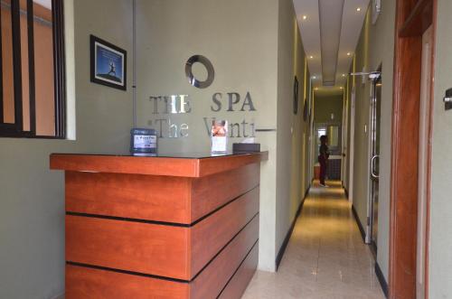 a salon with a wooden counter in a hallway at The Venti Hotel & Spa in Kampala