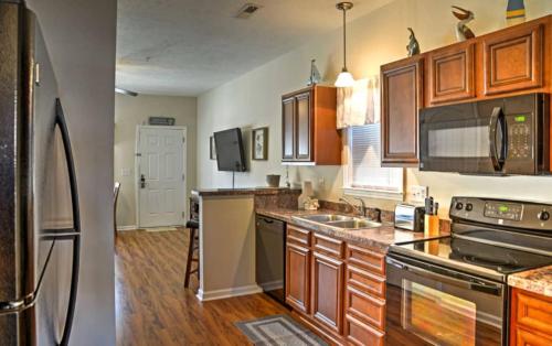 a kitchen with wooden cabinets and a stove top oven at Gulf Stream Cottages 300 in Myrtle Beach