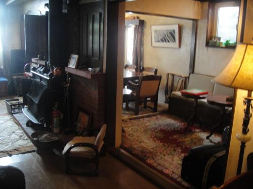a living room with a table and a mirror at Grandpapa in Kutchan