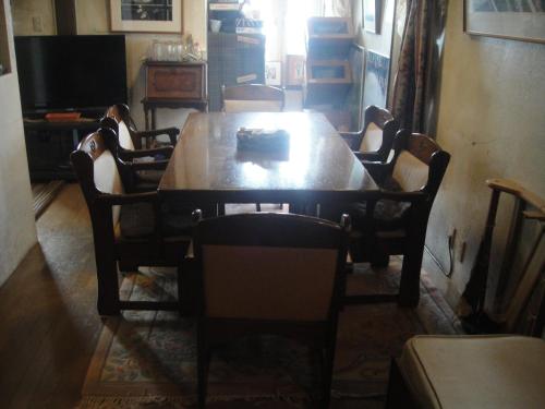 a dining room with a wooden table and chairs at Grandpapa in Kutchan