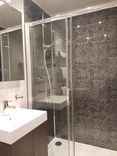 a bathroom with a shower and a sink at Compston House B & B in Ambleside