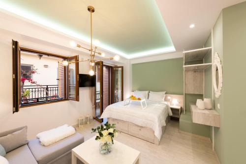 a bedroom with a bed and a living room at Feels like Home in Rethymno Town