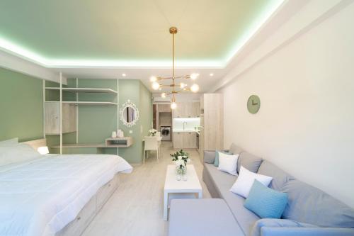 a bedroom with a large bed and a couch at Feels like Home in Rethymno Town