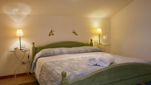 a bedroom with a bed with two towels on it at La Meridiana Affittacamere in Colorno
