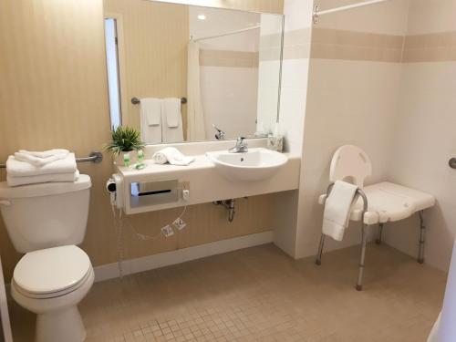 a bathroom with a toilet and a sink and a mirror at The Water Tower Inn - BW Premier Collection in Sault Ste. Marie