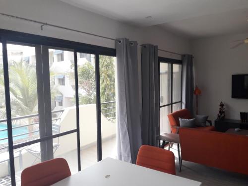 a living room with a view of a patio at Studio Sunshine in Saly Portudal