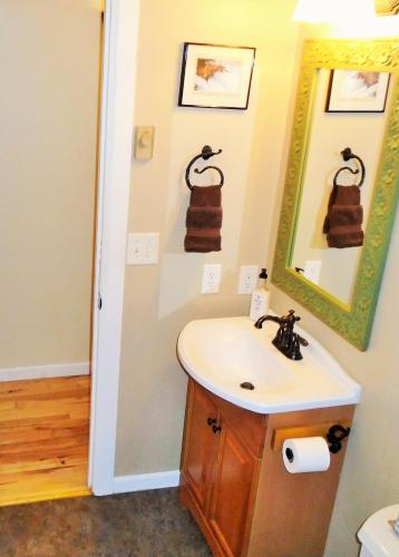 a bathroom with a sink and a mirror at Cozy Mountain Home with Deck and Firepit-1 Mile from Downtown Flagstaff! in Flagstaff
