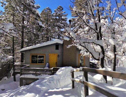 a small house in the snow with a fence at Cozy Mountain Home with Deck and Firepit-1 Mile from Downtown Flagstaff! in Flagstaff