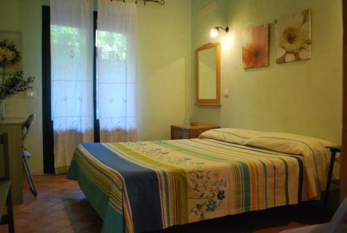 a bedroom with two beds and a mirror at Case Vacanze Fossanave in Santa Tecla