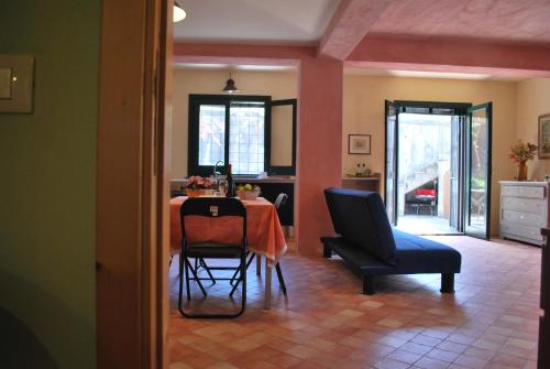 a dining room with a table and a chair at Case Vacanze Fossanave in Santa Tecla