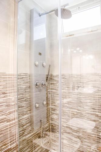 a shower with a glass door in a bathroom at Casa Rachele in Corralejo
