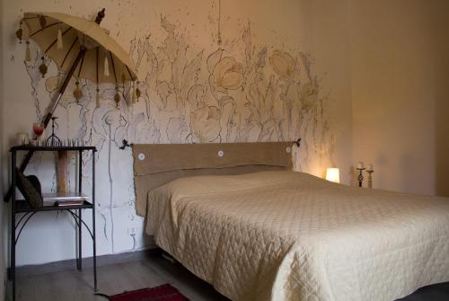 a bedroom with a bed and a wall with a painting at Da Rita in San Terenzo