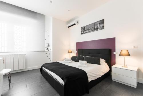 a bedroom with a large bed with a purple headboard at Casa Paestum. Your wonderful garden in Rome in Rome