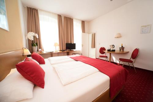 Postel nebo postele na pokoji v ubytování City-Hotel Am Wasserturm Halle