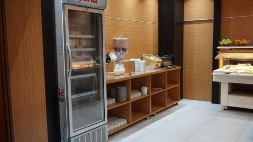 a kitchen with a refrigerator with dishes in it at Meka Hotel in Dragash