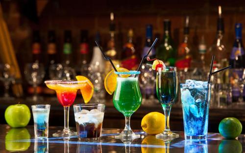 a group of different cocktails sitting on a bar at Souvenir Jaipur in Jaipur