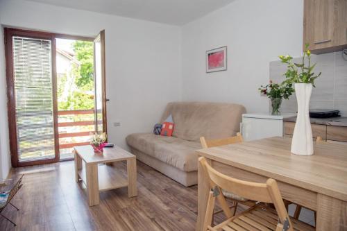 a living room with a table and a couch at Zeleno srce in Soko Banja