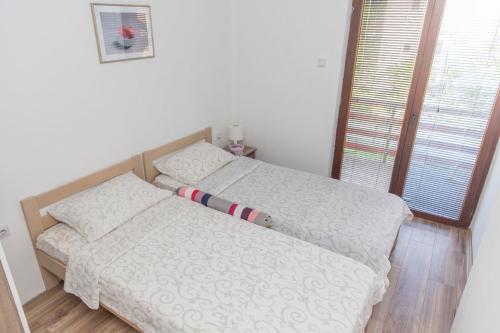 a bedroom with a bed with a baseball bat on it at Zeleno srce in Soko Banja