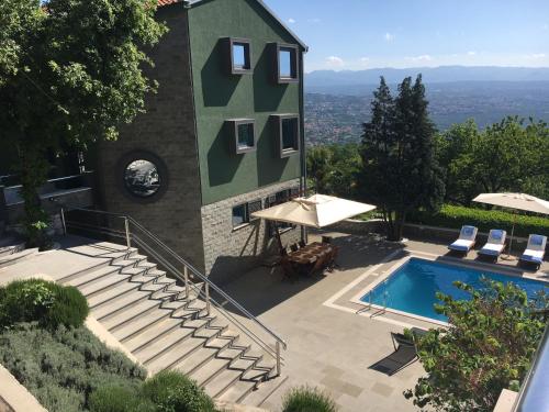 a building with a swimming pool next to a resort at Luxury Apartment with private pool and 2 bedrooms in Villa Opatija Bay View in Opatija