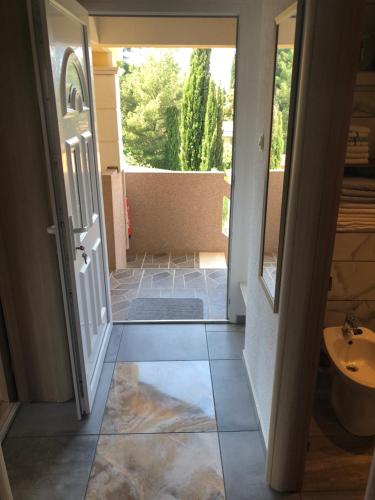 a door leading into a bathroom with a sink at Apartments Ivanković in Stari Grad