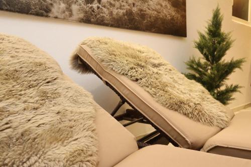 a living room with a couch and a christmas tree at Appartement Hänsel & Gretel in Werfenweng