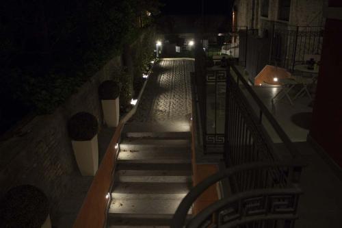 a set of stairs with lights at night at Palazzo Domanto Apartments Parma in Parma