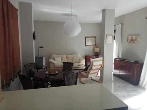 a living room with a couch and a table at Charming Villadarias M. Palace apartment in Antequera
