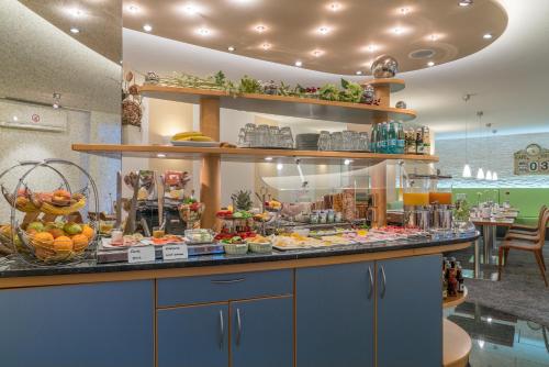 a buffet line with a lot of food on display at Airporthotel Residenz Steinenbronn in Steinenbronn
