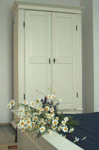 a bouquet of flowers in front of a white cabinet at Frăgăria in Zimandcuz