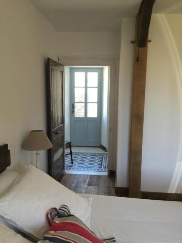 a bedroom with a bed and a hallway with a door at Le Pas Saint Joseph in Saint Malo