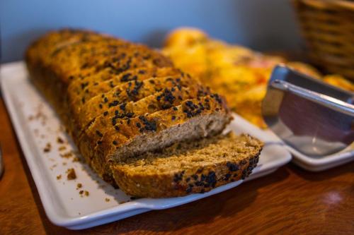 a loaf of bread on a plate on a table at Pousada Renda do Mar in Morro de São Paulo