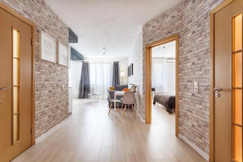 a room with a brick wall and a dining room at Minsk Apartment in Minsk