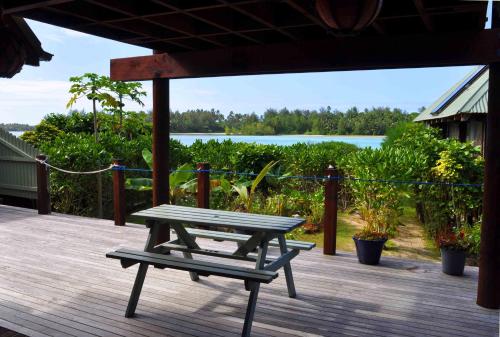 a picnic table and a bench on a deck at Sokala Villas in Muri