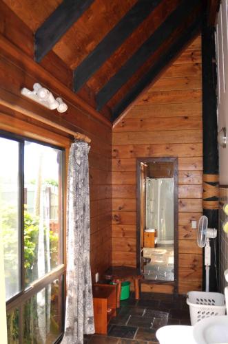 a bathroom with wooden walls and a large window at Sokala Villas in Muri