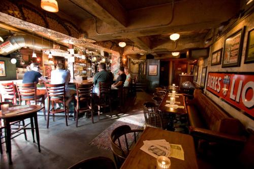 a restaurant with people sitting at tables in a bar at McMenamins Crystal Hotel in Portland