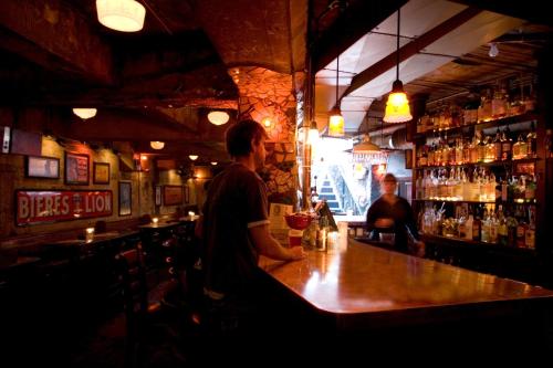 a man sitting at a bar in a pub at McMenamins Crystal Hotel in Portland