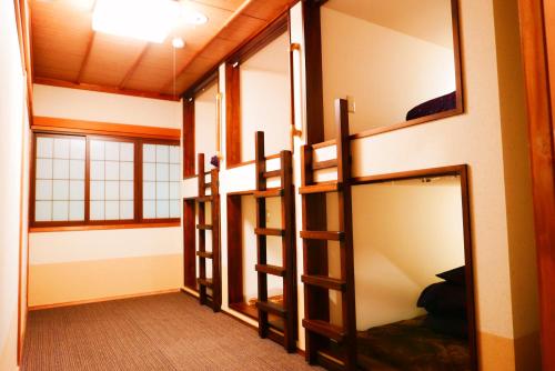 a room with three bunk beds in a room at K's House Takayama Oasis [2nd K's Hostel] in Takayama