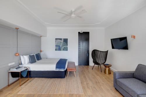 a hotel room with a bed and a couch at Regents Court Sydney in Sydney