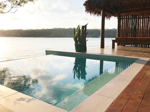 a swimming pool with a view of the water at Erakor Island Resort & Spa in Port Vila