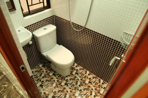 a bathroom with a toilet and a sink at European Hostel in Hong Kong