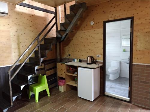 a bathroom with a staircase and a sink and a toilet at Jama Bay in Xiyu