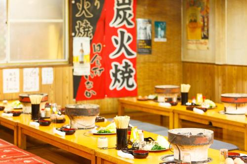 a row of tables with plates of food on them at Yufuin Inakamura Inakaso in Yufuin