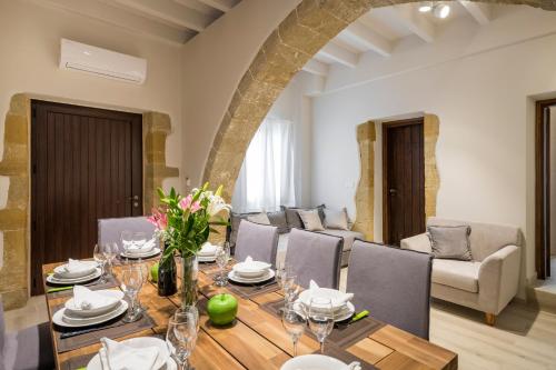 a dining room with a table and chairs at Spilia Village Hotel & Villas in Spiliá