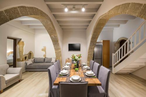 a dining room with a long table and chairs at Spilia Village Hotel & Villas in Spiliá