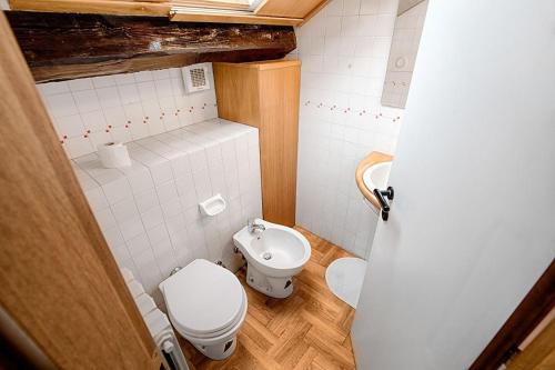 a small bathroom with a toilet and a sink at Duomo-City Life In The Heart Of The City! in Milan